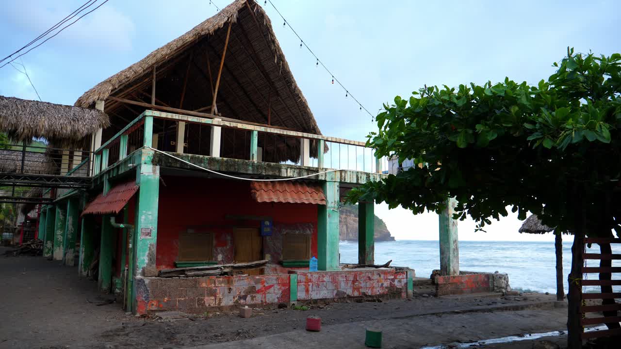 Full shot, scenic view of a beach house on the beach front of the bitcoin beach in El Salvador, Mexico, blue sky and waves in the background