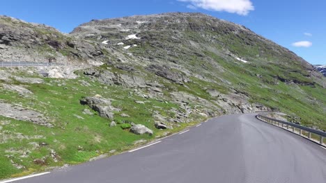 couple goes on a mountain road in norway by camper van rv.