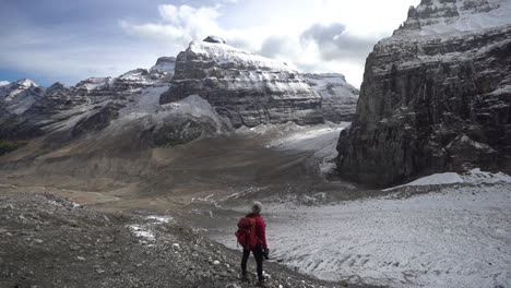 hiker under glacier in canadian rockies