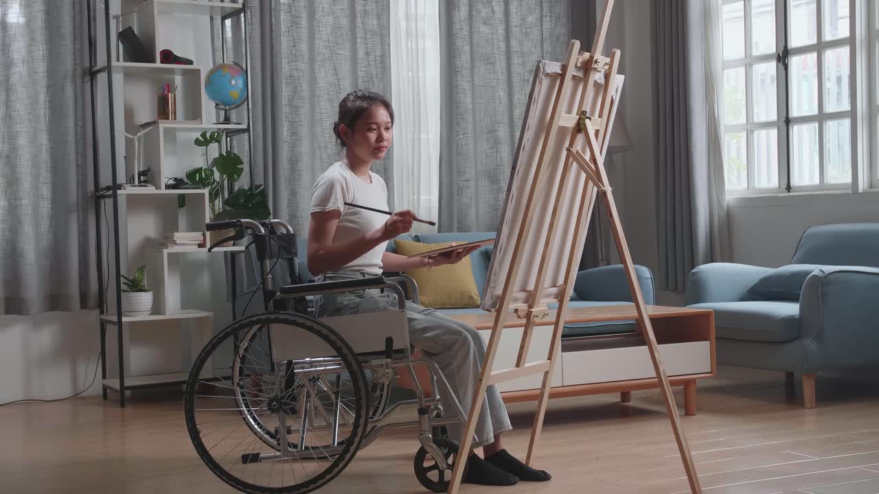 Woman in Wheelchair Painting at Home