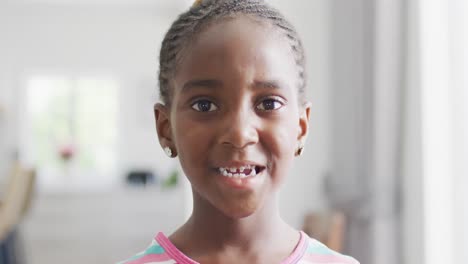 Video-portrait-of-happy-african-american-girl-looking-straight-to-camera-and-smiling