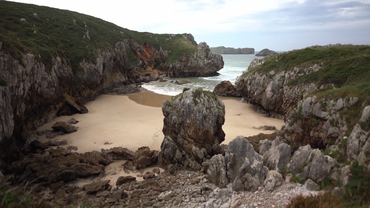Hidden remote secret beach waves crashing to cantabrian sea coastline