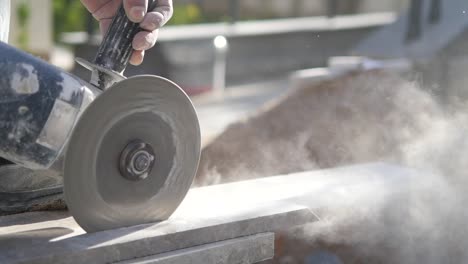 construction worker cutting stone with a grinder