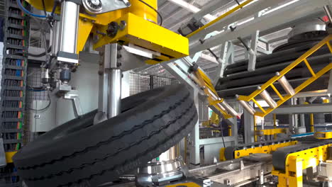 Automated-science-mechanical-tire-production-technology-view-at-modern-industrial-factory-closeup-real-shot