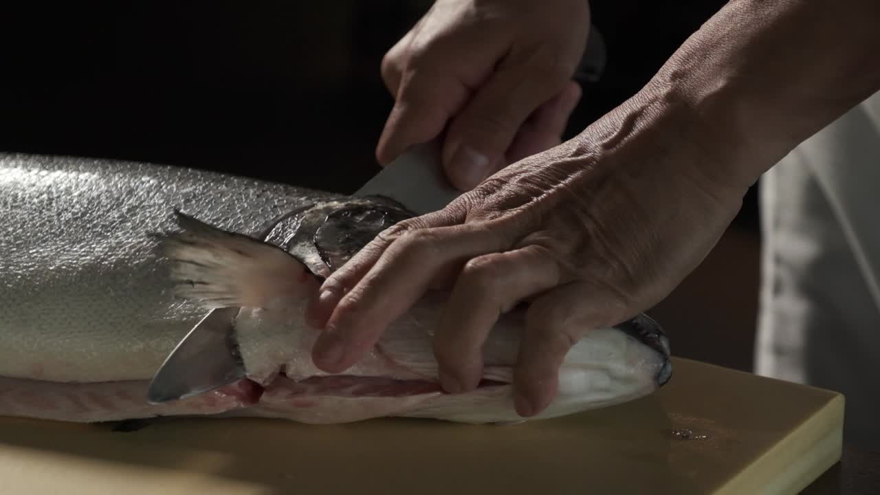 Chef preparing fresh salmon in the kitchen
