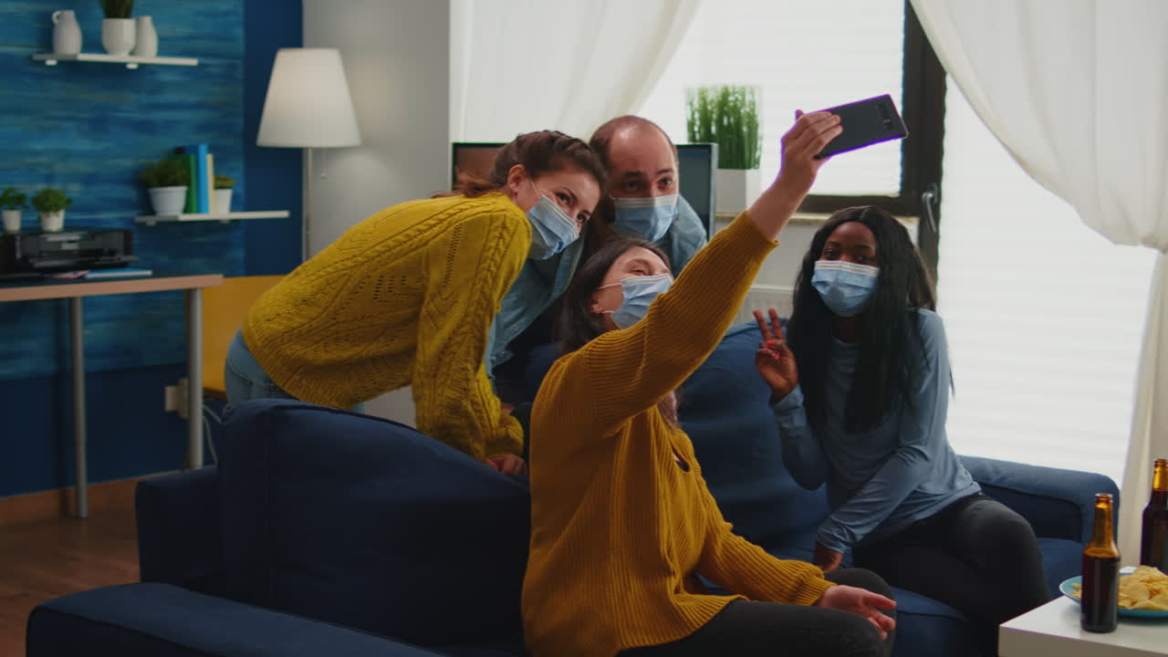 Multiracial friends taking selfie with face masks during covid 19 outbreak