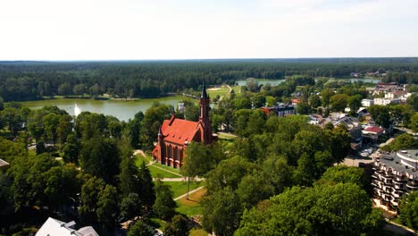 Aerial shot of the Catholic Church of Saint Mary&#039;s Scapular in Druskininkai, Lithuania on a sunny summer day, parallax