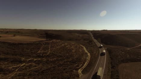 aerial shot of highway in spain, cars and trucks driving by