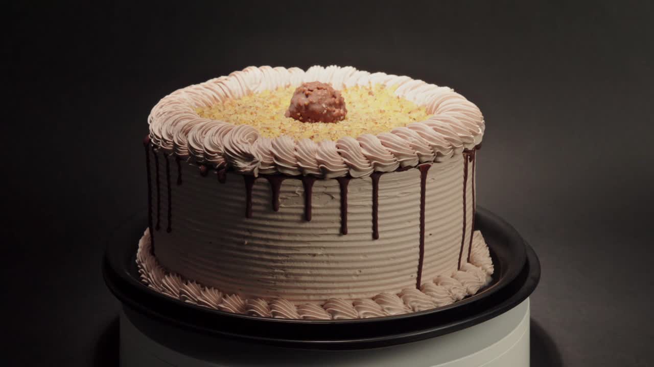 Ferrero rocher cake delicious tasty treat chocolate hazelnut in a turn table loop black background