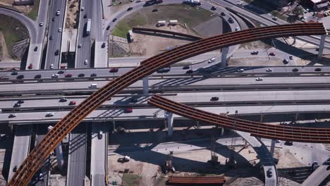 construction resumes along an overpass with steel beams and concrete pillars