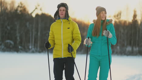 family skiers spend the weekend together doing skiing in the woods. healthy lifestyle. slow motion. loving couple