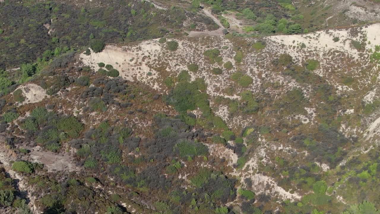 Stunning aerial view of lush hills and rocky terrain in Greece
