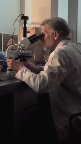 scientist using a microscope