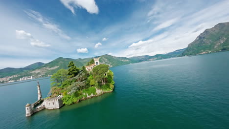 Scenic-view-of-Loreto's-Island-in-Lago-d'Iseo-surrounded-by-mountains-and-calm-water