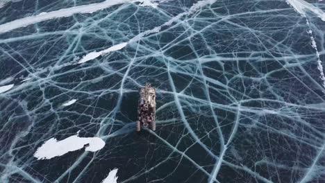 drone-view-of-epic-military-vehicle-movie-scene-on-lake-baikal-winter-daytime-at-Russia