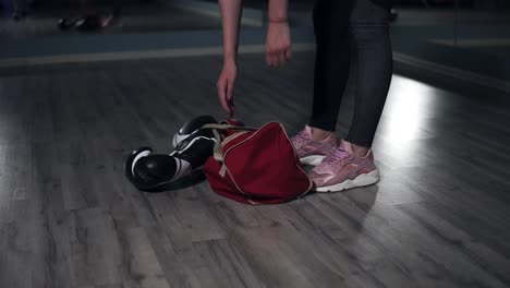 closeup view of woman's legs walking in a boxing club. young female boxer putting down her bag and taking out a bottle with water preparing for training. shot in 4k