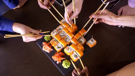 business team eating sushi