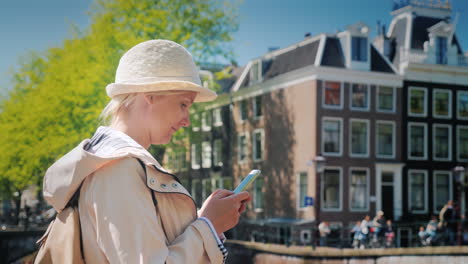 young woman smartphone in amsterdam