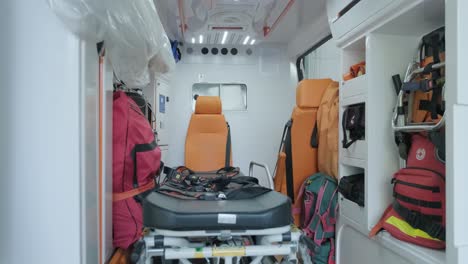 inside the ambulance, view from the sanitary compartment. different medical equipment and a stretcher.