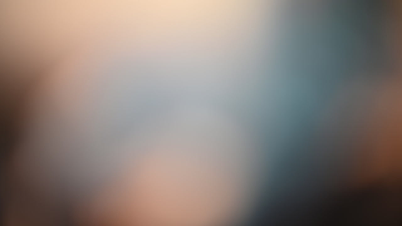 Abstract blurred background with beige, blue, and brown tones
