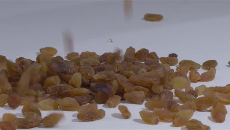 golden raisins poured on a white table