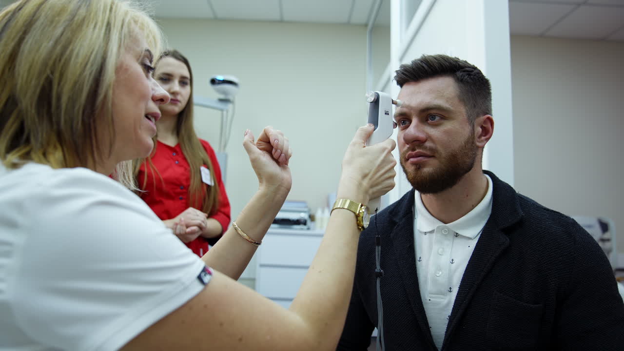 Vision test in optician office. Female doctor examining eye structure with medical equipment