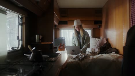 woman working on laptop in camper van