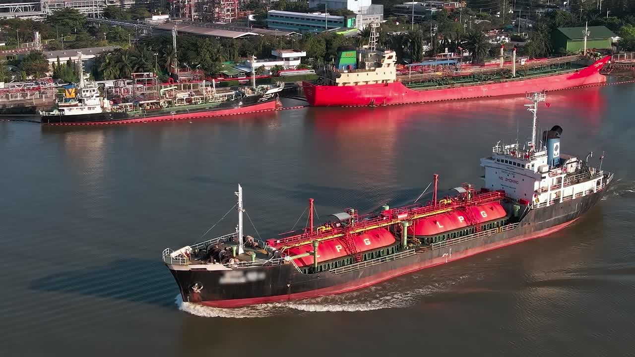Ships navigate the Chao Phraya River in Bangkok during afternoon