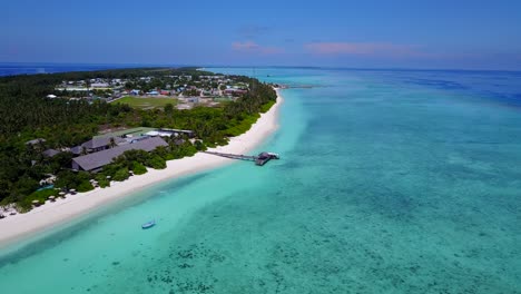 aerial-view-of-a-resort-on-the-Maldives-with-white-sandy-beaches,-and-deep-dark-blue-sea