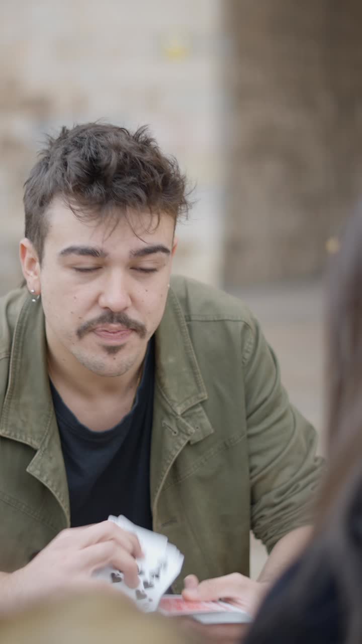 A man playing cards and showing various expressions