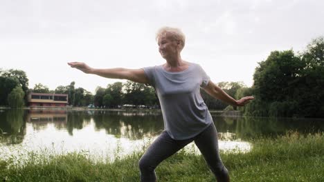 Wide-shot-of-senior-woman-practicing-yoga-in-the-sunset