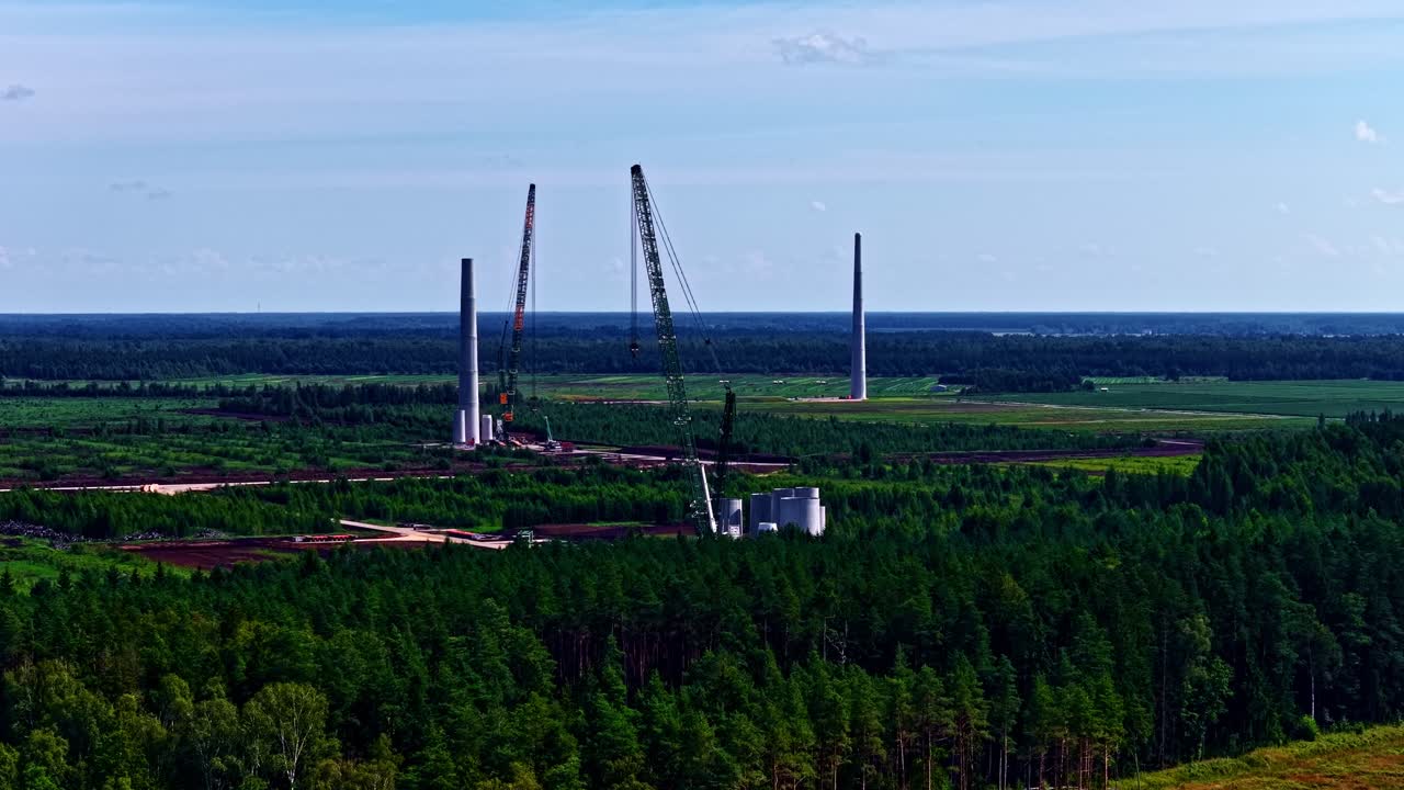 Wind turbine farm building site under construction renewable green energy, aerial drone