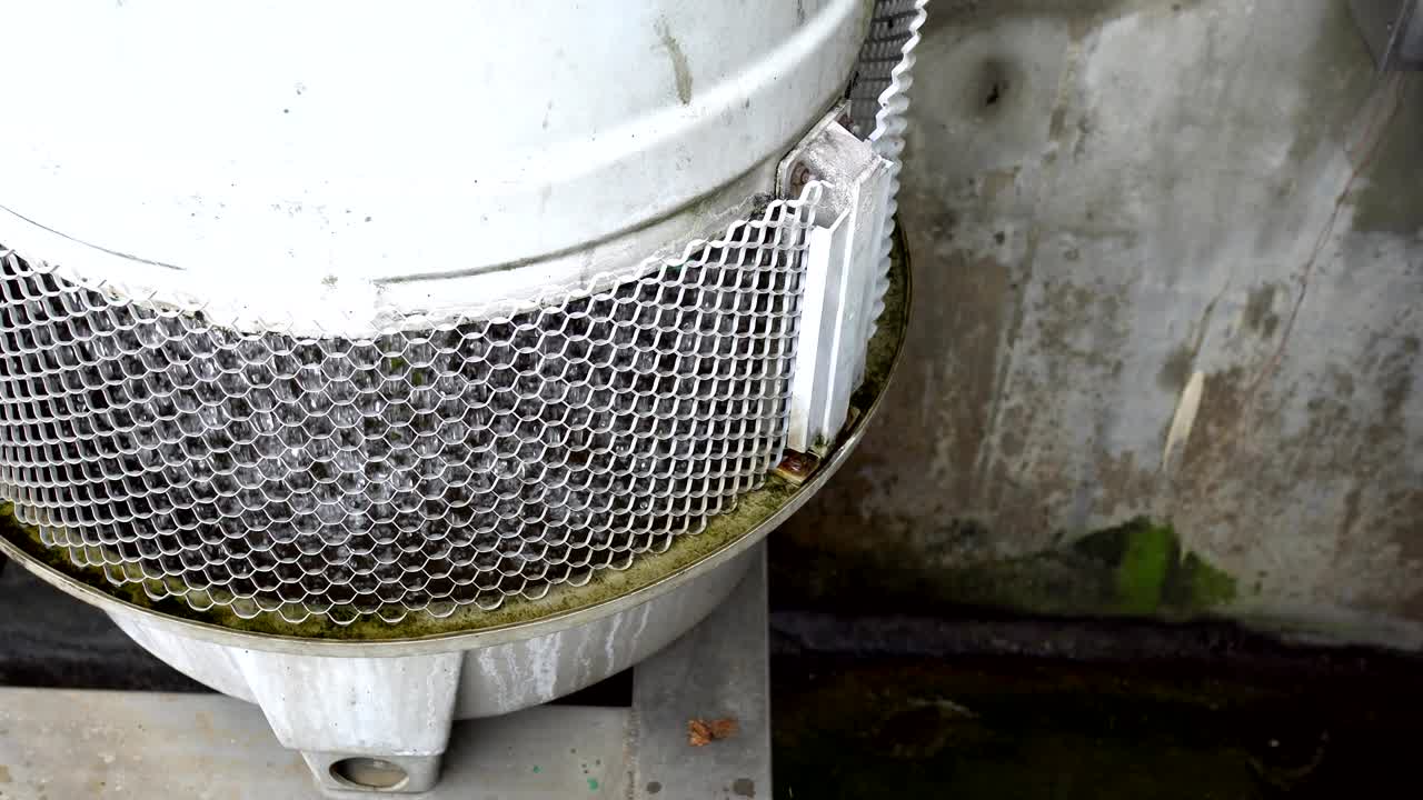 3 phase induction motor. The function is to drain or pump water. The exterior is old and rusty. The subject is on the left.