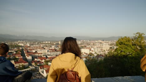 tourists observing ljubljana city in slovenia from panoramic point of view