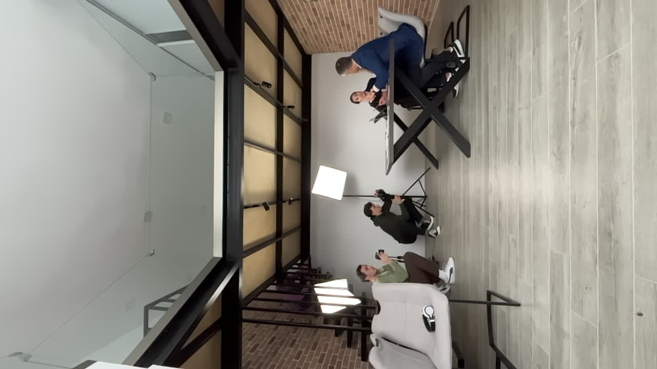 Time-lapse de pessoas filmando colegas de trabalho durante uma reunião em um escritório. Vertical