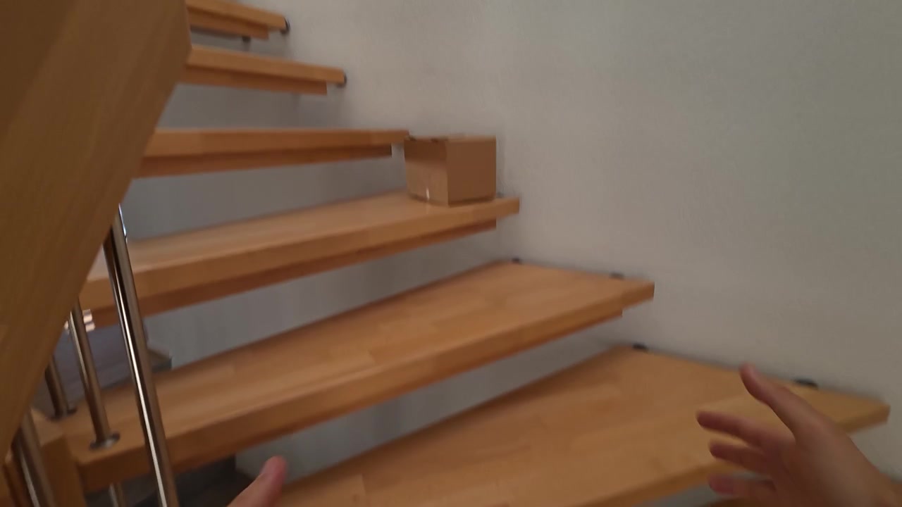 POV of accidentally dropping a cardboard package in slow motion. Ideal for delivery, shipping, packaging, and accident concepts.