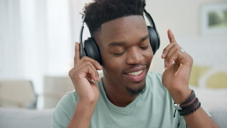 black man, headphones and dancing to music