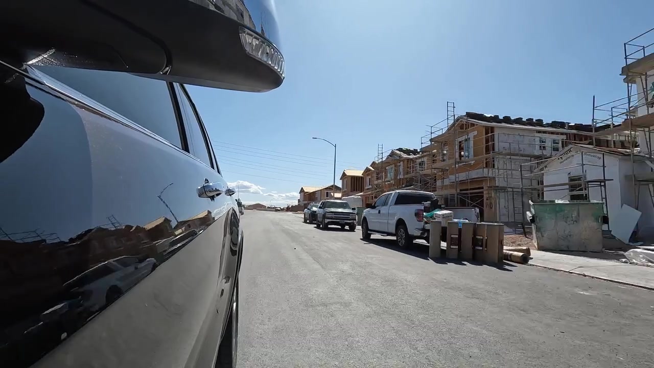 POV di un veicolo che gira in una strada di un quartiere residenziale con case di nuova costruzione