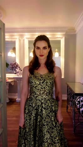 woman in a gold and green formal gown