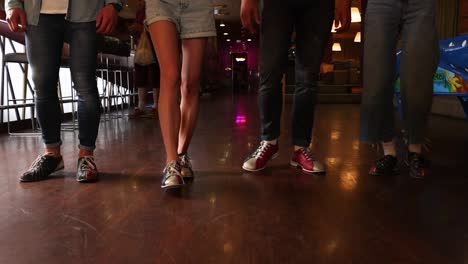 friends walking in a bowling alley