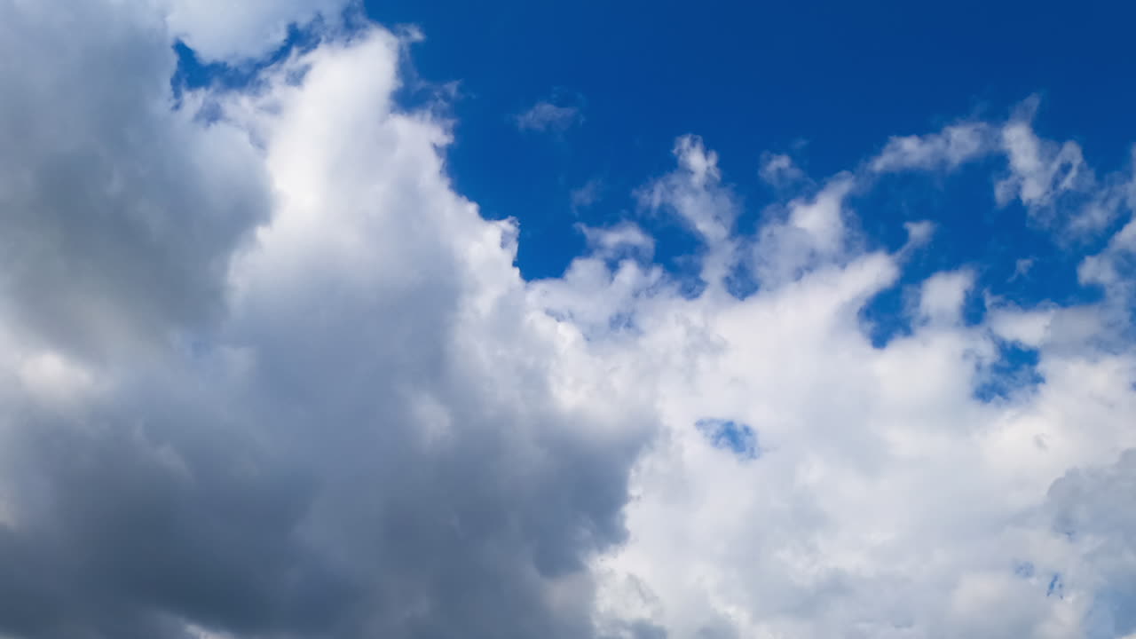 Clouds timelapse in the sky. Clouds drift swiftly across a bright blue sky, showcasing a dynamic movement in a serene natural setting