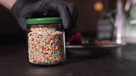 glass jar full of edible colorful confetti, slow motion rotating jar full of confetti, healthy traditional cooking and fitness