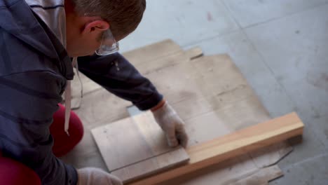 repair and decoration. a man cuts ceramic tiles with a grinder.