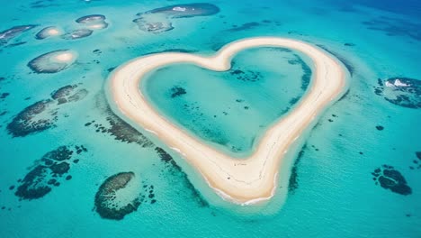 aerial view of a stunning heart-shaped sandbar surrounded by turquoise waters, showcasing the natural beauty of coastal landscapes and unique geographical formations