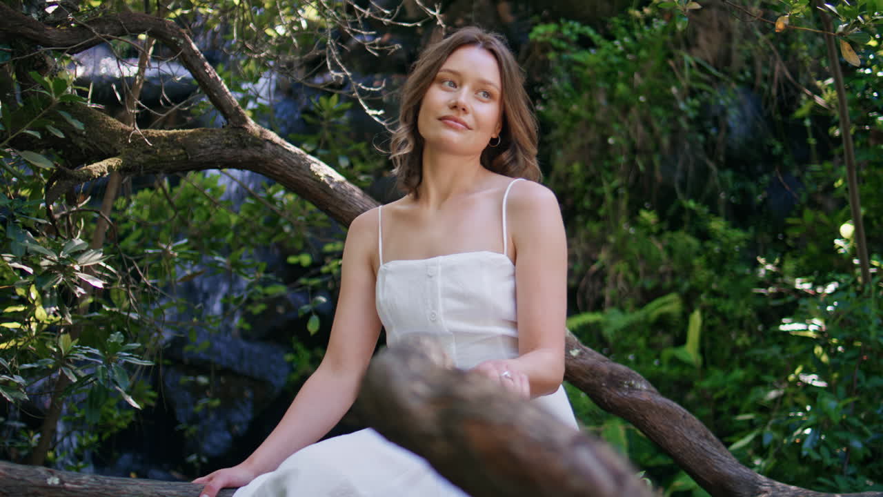 Forest girl sitting tree resting alone closeup. Romantic lady looking camera