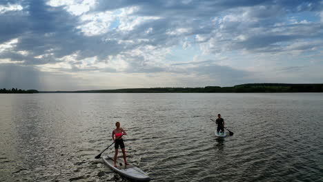 people relaxing on paddle sup board. aerial view of surfers floating sup board on vacation