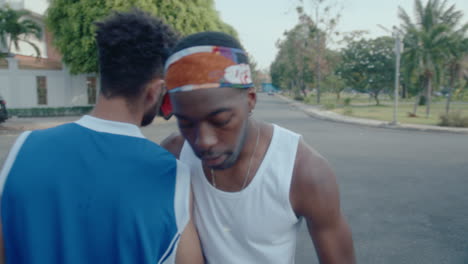 male friends meeting on the street and playing basketball