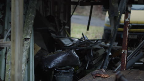 Hanging-rusty-metal-and-other-trash-on-abandoned-property