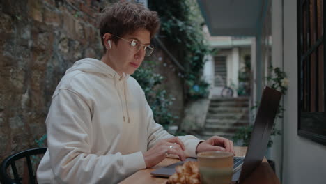 girl working on laptop in a small patio