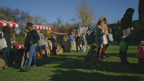 people walking and shopping on farmers market people walking and shopping on urban farmers market choose fresh products care about health and spending day off by buys proper nutrition autumn fair outdoors